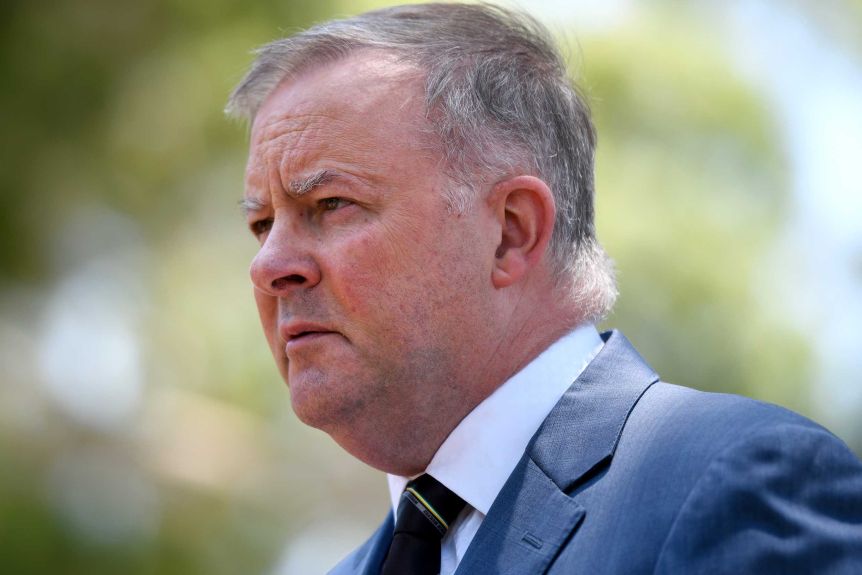 A close up shot of Anthony Albanese looking away from the camera, with a concerned expression. 